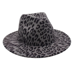 Close-up of vintage wide brim fedora hat with leopard print pattern on grey felt material