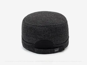 Detail view of dark grey winter cadet hat with elastic back band and brand logo tag
