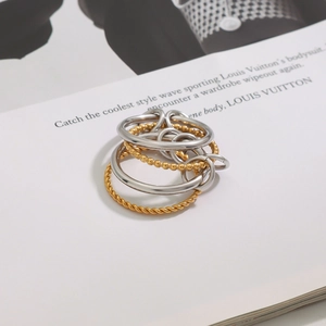Detail of interlocking gold and silver rings with twisted rope and beaded textures