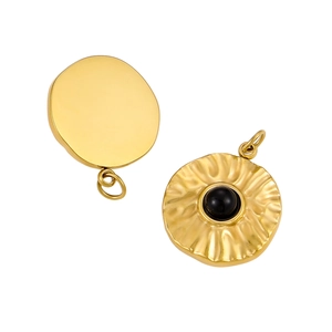 Detail of vintage gold stainless steel pendants with sunburst texture and black stone