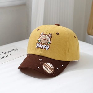 Detail of yellow kids baseball cap featuring cartoon dog embroidery and star pattern brim