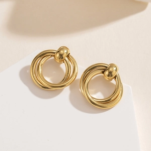Macro shot of 14K gold-plated multilayered circular stud earrings with polished finish