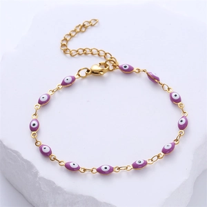 Detailed macro view of purple oval Evil Eye pendants on a gold stainless steel chain
