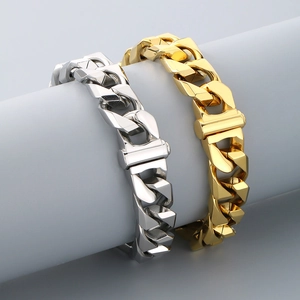 Close-up of 13mm silver and gold Cuban link bracelets on a grey display stand