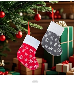Close-up of red and grey Christmas stocking ornaments with snowflakes on a festive tree