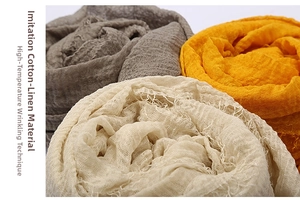 Close-up of pleated cotton-linen texture scarves with soft frayed edges in neutral tones