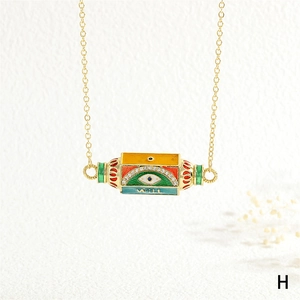 Detailed shot of hexagonal enamel pendant with evil eye motif and gold-plated chain