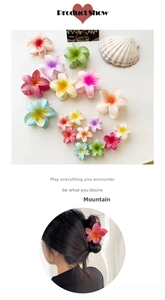 Detail of gradient candy color plumeria hair claws in various sizes for beach styling