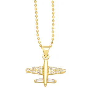 Chic gold airplane pendant necklace with sparkling white zircons on a beaded chain