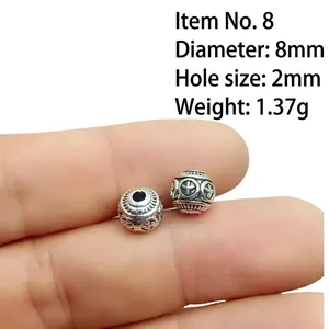 Macro shot of 8mm silver alloy cross bead showing diameter 8mm and 2mm aperture