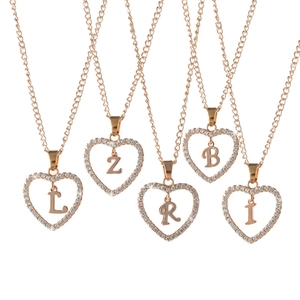 Rose gold heart pendants with diamonds and initials L Z R B I on a white background