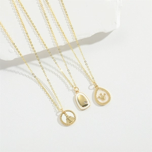 Minimalist gold necklace set featuring crown pendant and vintage religious medallions