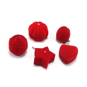 Detailed view of red velvet jewelry boxes in rose, star, pumpkin, and heart shapes