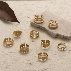 Set of adjustable gold stainless steel rings featuring moon, leaf, and sun patterns