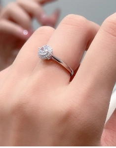 Macro shot of 925 silver ring featuring a round moissanite center stone and halo design