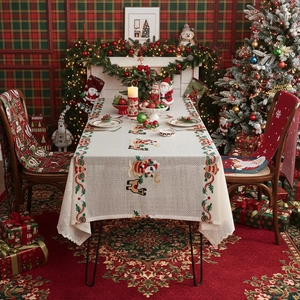 Christmas tablecloth with festive red and green Santa Claus embroidery and lace edges