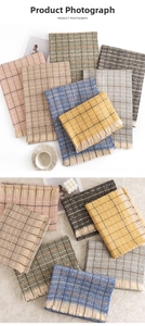 Detailed view of plaid scarves with tassels and subtle sequins in Morandi colors