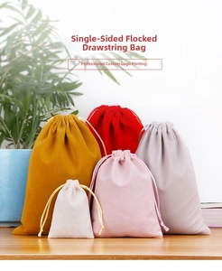 Single-sided velvet drawstring bags in five colors on a rustic wooden table setting