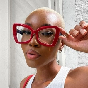 Close-up of stylish oversized red geometric cat-eye glasses worn by a female model