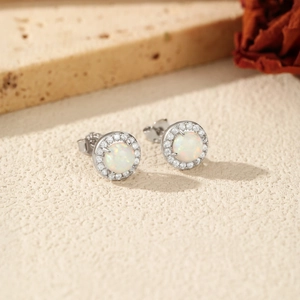 S925 sterling silver opal stud earrings with zirconia halo on a textured stone surface