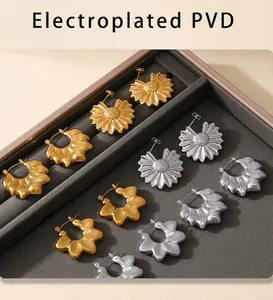 Detail of flower earrings in gold and silver finish with PVD electroplated coating