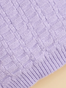 Detail of purple knitted pet sweater showing checkerboard texture and ribbed hem