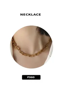 Close-up of a gold U-shaped link chain necklace on model, modern 18k plated steel jewelry