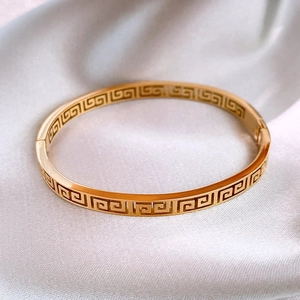 Minimalist 18K gold-plated stainless steel bangle with hollow Greek key pattern design