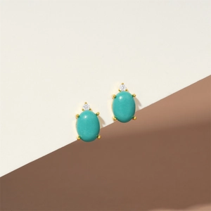 Macro detail of S925 silver turquoise flower earring with gold plating and zircon stud