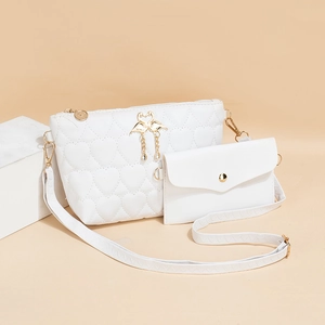 White quilted crossbody bag set with heart stitching and golden swan tassel hardware
