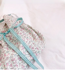 Detail of floral canvas tote showing light breathable fabric and drawstring texture
