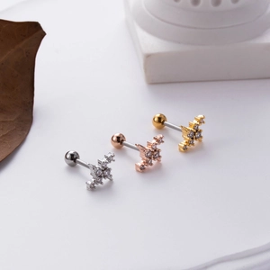 Detailed macro view of barbell screw back earrings in silver, gold and rose gold