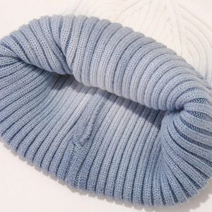 Close-up of blue tie-dye ribbed knit beanie showing thick texture and warm ear protection