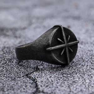 Detailed close-up of retro silver compass cross ring with antique nautical engraving