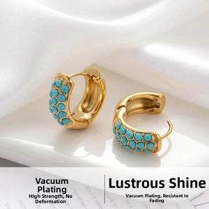 Detail of vintage gold C-shape hoop earrings with three rows of inlaid green turquoise beads