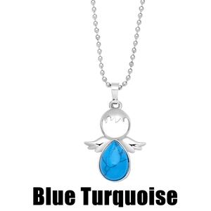 Macro shot of silver angel pendant featuring a teardrop blue turquoise with bead chain