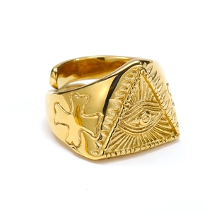 Macro view of gold All-Seeing Eye ring with embossed cross detail and adjustable open band