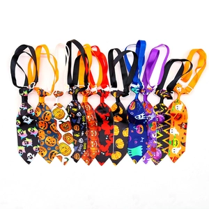 Detail view of eleven Halloween pet neckties with pumpkin and bat patterns and buckles