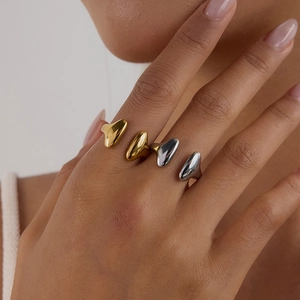 Polished stainless steel rings in gold and silver colors with irregular organic shapes