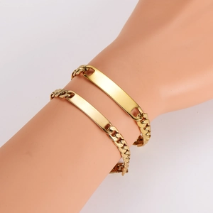 Men's hip hop gold Cuban link ID bracelet with flat rectangle plate shown on wrist