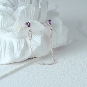 Macro detail of S925 sterling silver tassel earrings with purple heart zirconia stones