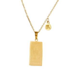 Detailed macro view of gold Scorpio zodiac pendant with engraved celestial patterns