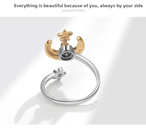 Detail view of silver and gold star moon spinning ring with sparkling stone accents