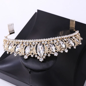 Detailed macro view of golden bridal tiara with rhinestones on a black stand
