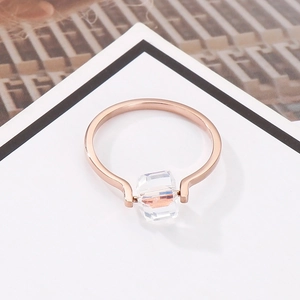 Minimalist rose gold ring featuring a rotatable square-cut clear crystal on a white card