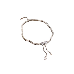 Zircon bow necklace with heart stones and pearl tassels for women on white background