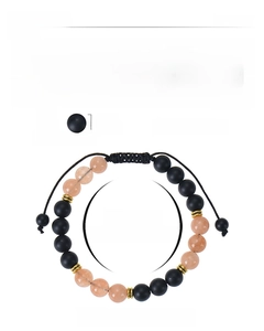 Detail view of 8mm sunstone and matte black stone braided bracelet with size specifications