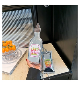 Detailed view of creative silver sauce bottle bag with Lost in the Sauce typography