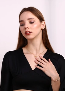 Detail of 18K gold plated bow jewelry set including necklace, earrings and bracelet