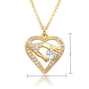 Macro detail of a 17mm gold heart pendant with hollow design and white zircon stones